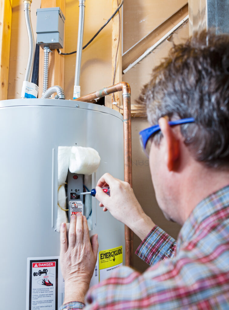 Contractor installing heat pump water heater