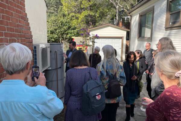 Montclair Presbyterian Church’s Reverend, Ben Daniel, points out details of the heat pump water heater to congregation members.